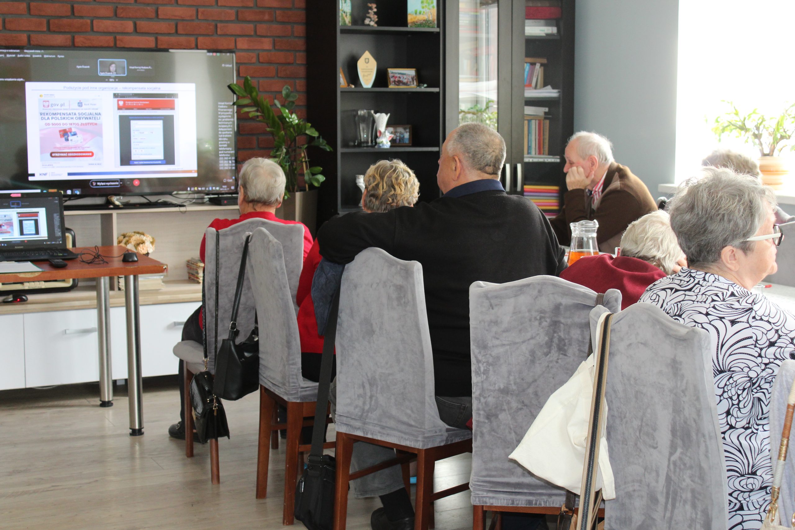Na zdjęciu seniorzy słuchający webinarium o cyberbezpieczeństwie