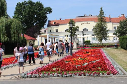 Uczestnicy wycieczki idą w kierunku restauracji zdrojowa.